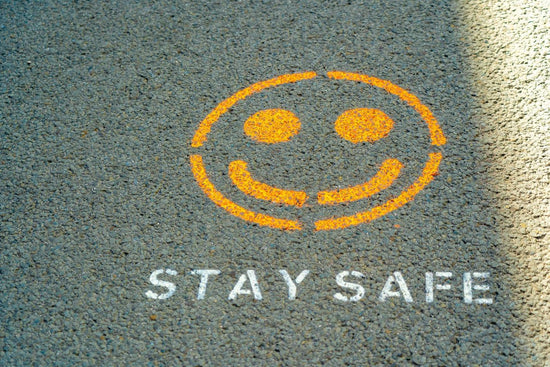 smilie face on tar with words stay safe underneath